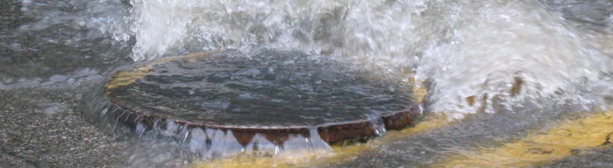 water is blocked through a manhole on the road